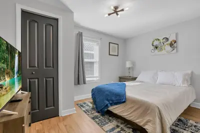a bedroom with a bed and a flat screen tv at Nostalgic in Nelsonville in Nelsonville