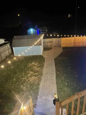 a garden with a fountain at night with lights at Nostalgic in Nelsonville in Nelsonville