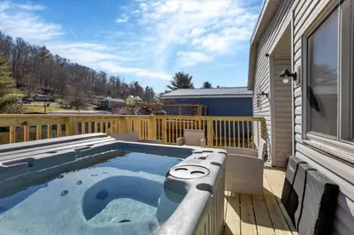 a hot tub on the deck of a house at Nostalgic in Nelsonville in Nelsonville