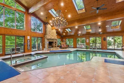 an indoor pool in a house with a large room with windows at Daisy Glen Retreat - Amazing Indoor Pool in South Bloomingville