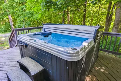 a hot tub sitting on a wooden deck at Daisy Glen Retreat - Amazing Indoor Pool in South Bloomingville