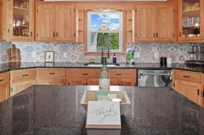 a bottle of wine sitting on top of a kitchen counter at Cattle Cottage