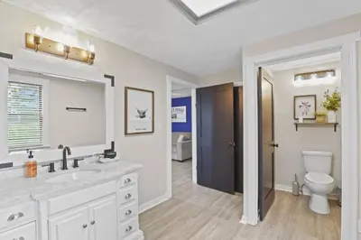 a white bathroom with a sink and a toilet at Cattle Cottage