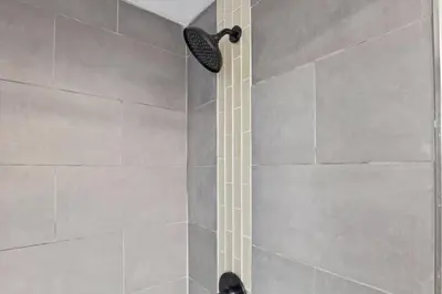 a shower with a shower head in a bathroom at Cattle Cottage