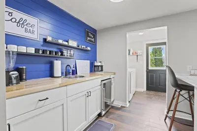 a kitchen with a blue wall and a counter at Cattle Cottage