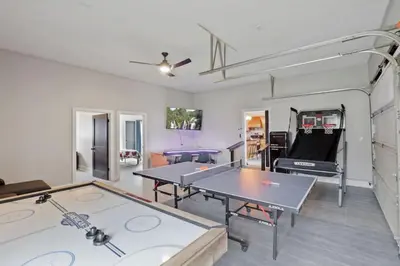 a living room with two ping pong tables in it at Cattle Cottage