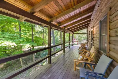 a porch of a cabin with rocking chairs on it at Hike Away Hills in Logan