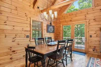 a dining room with a wooden table and chairs at Hike Away Hills in Logan