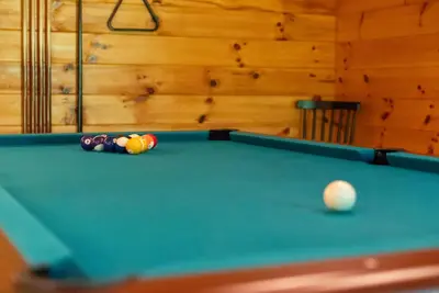 a billiard table with a ball in a room at Hike Away Hills in Logan