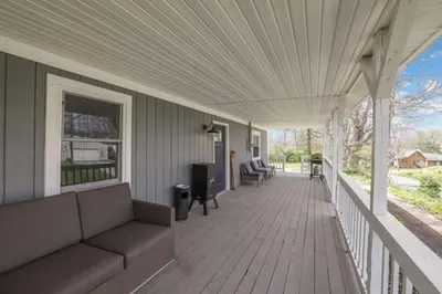 a porch with a couch and chairs on a house at The Landing Spot in Pataskala