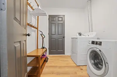 a laundry room with a washing machine and a sink at The Landing Spot in Pataskala