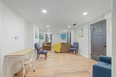 a living room with blue chairs and a table at The Landing Spot in Pataskala