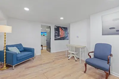 a living room with two blue chairs and a table at The Landing Spot in Pataskala