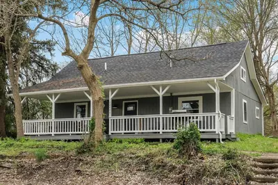 a gray house with a white porch at The Landing Spot in Pataskala