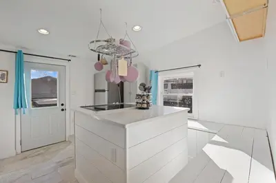 a kitchen with white cabinets and a counter top at The Shack in Buckeye Lake