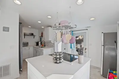 a kitchen with white cabinets and a chandelier at The Shack in Buckeye Lake