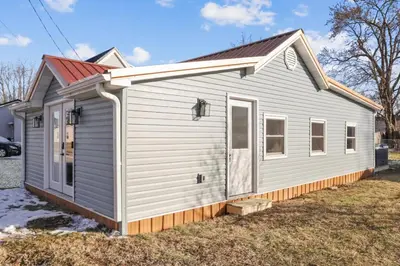 a white tiny house with a red roof at The Shack in Buckeye Lake