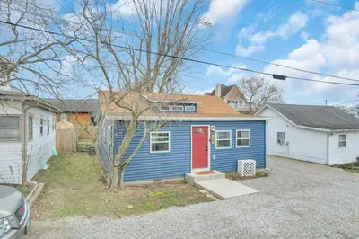 a blue tiny house with a red door at Gone Fishin in Buckeye Lake