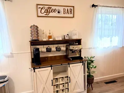 a coffee and bar in a room with a coffee maker on a shelf at Ranch-3 Bedroom-Pet & Kid-Fenced -EV Charging-King Bed in Gahanna