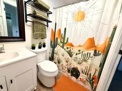 a bathroom with a toilet and a shower curtain with cactus at Ranch-3 Bedroom-Pet & Kid-Fenced -EV Charging-King Bed in Gahanna