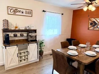 a dining room with a table and a coffee bar at Ranch-3 Bedroom-Pet & Kid-Fenced -EV Charging-King Bed in Gahanna