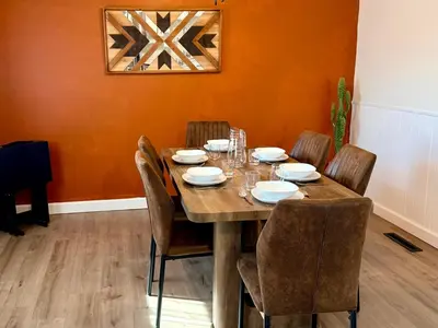 a dining room with a wooden table and chairs at Ranch-3 Bedroom-Pet & Kid-Fenced -EV Charging-King Bed in Gahanna