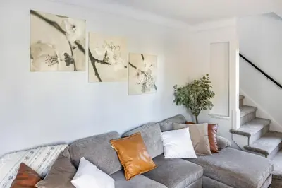 a living room with a gray couch with pillows at Euclid Near Lake Erie Cleveland king bed in Euclid