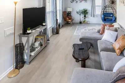 a living room with a couch and a television at Euclid Near Lake Erie Cleveland king bed in Euclid