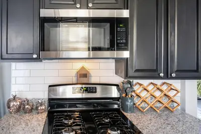 a kitchen with a stove and a microwave at Euclid Near Lake Erie Cleveland king bed in Euclid