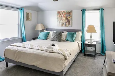 a bedroom with a bed with a stuffed animal on it at Euclid Near Lake Erie Cleveland king bed in Euclid