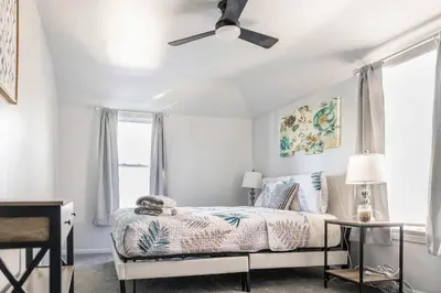 a bedroom with a bed and a ceiling fan at Euclid Near Lake Erie Cleveland king bed in Euclid