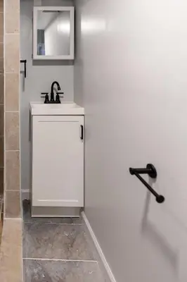 a white bathroom with a sink and a mirror at Euclid Near Lake Erie Cleveland king bed in Euclid