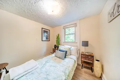 a bedroom with a bed and a window at Cuyahoga Falls 3 bedroom 2 bath in Cuyahoga Falls