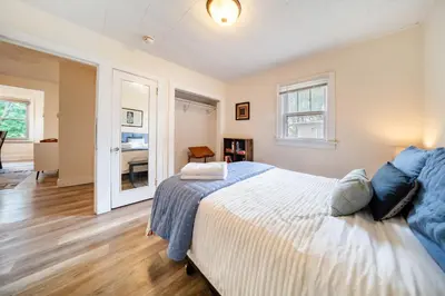 a bedroom with a large bed with blue pillows at Cuyahoga Falls 3 bedroom 2 bath in Cuyahoga Falls