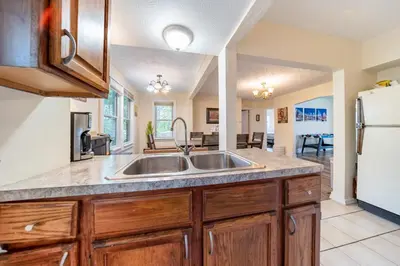 a kitchen with a sink and a refrigerator at Cuyahoga Falls 3 bedroom 2 bath in Cuyahoga Falls