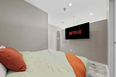 a bedroom with a bed and a television on the wall at 1BR • City View • Huntington • King Bed • 2 TVs in Cleveland