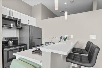 a kitchen with a white counter and black appliances at 1BR • City View • Huntington • King Bed • 2 TVs in Cleveland