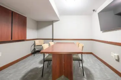 a conference room with a wooden table and chairs at 1BR • City View • Huntington • King Bed • 2 TVs in Cleveland