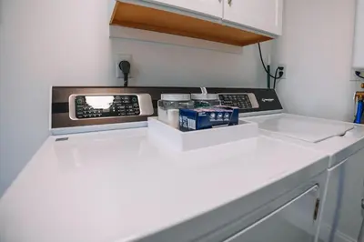 a kitchen with a microwave on a white counter at Grandma's Place - Steps from Downtown Sugarcreek in Sugarcreek