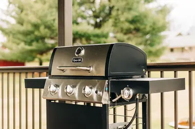 a black and silver grill sitting next to a fence at Grandma's Place - Steps from Downtown Sugarcreek in Sugarcreek