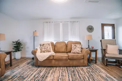 a living room with a couch and a chair at Grandma's Place - Steps from Downtown Sugarcreek in Sugarcreek