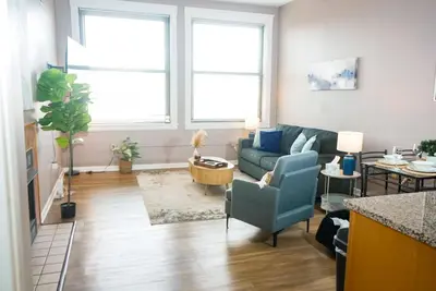 a living room with a couch and a table at Little Peaceful Loft in Cleveland