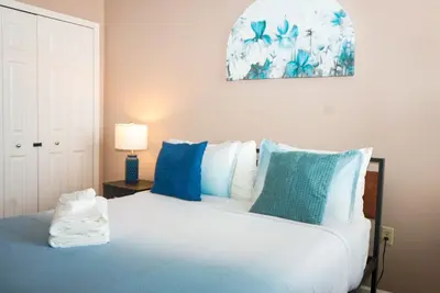 a bedroom with a bed with blue and white pillows at Little Peaceful Loft in Cleveland