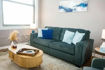 a living room with a couch and a coffee table at Little Peaceful Loft in Cleveland