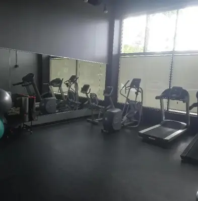 a gym with several treadms and elliptical machines at Little Peaceful Loft in Cleveland