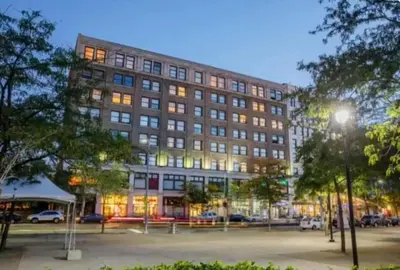 a large building with a parking lot in front of it at Little Peaceful Loft in Cleveland