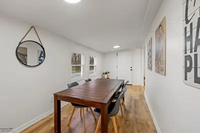 a dining room with a wooden table and chairs at Corporate Cottage on Circle in Thornville