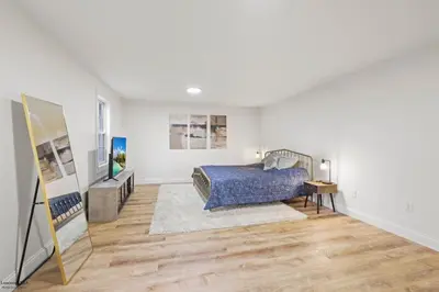 a bedroom with a bed and a television in it at Corporate Cottage on Circle in Thornville