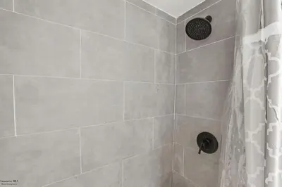 a bathroom with a shower with a shower curtain at Corporate Cottage on Circle in Thornville