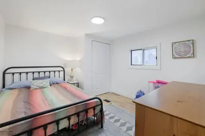 a bedroom with a bed and a table in a room at Corporate Cottage on Circle in Thornville
